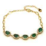 A 925 silver gilt bracelet set with oval cut emeralds and white stones, L. 17cm.