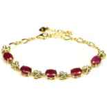 A 925 silver gilt bracelet set with oval cut rubies and white stones, L. 16cm.