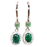 A pair of 925 silver drop earrings set with oval cut emeralds and white stones, L. 3cm.