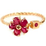 A 925 silver rose gold gilt flower shaped ring set with rubies, (O).
