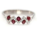 A 925 silver ring set with round cut rubies and white stones, (P).