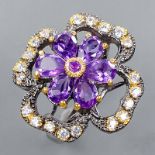 A 925 silver flower shaped ring set with oval cut amethysts and white stones, (P.), Dia. 2.7cm.