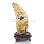 Ø AN UNUSUAL SCRIMSHAW DECORATED WHALE'S TOOTH