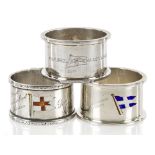 THREE SOUVENIR ENAMEL AND SILVER NAPKIN RINGS