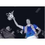 Autographed MIKE DOYLE 16 x 12 photo - Colorized, depicting the Manchester City captain holding