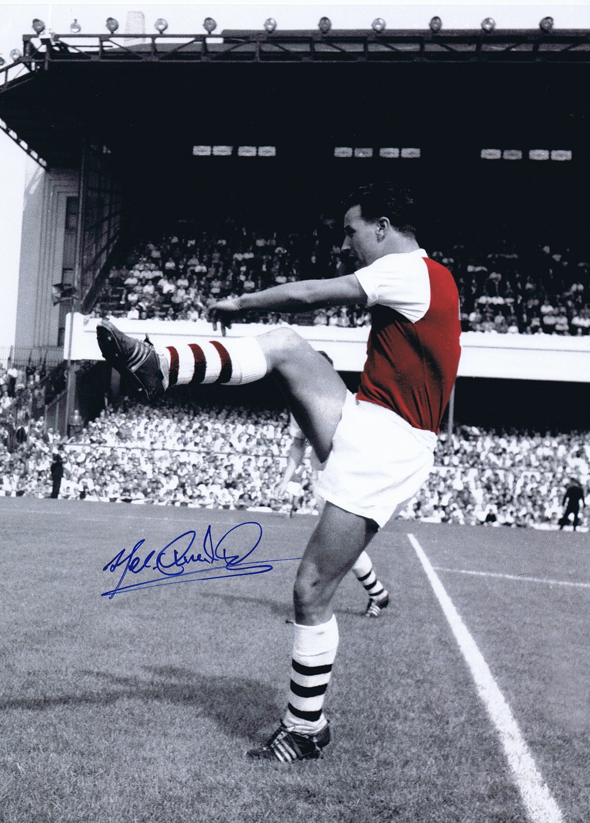 Autographed MEL CHARLES 16 x 12 photo - Colorized, depicting the Arsenal centre-forward warming up