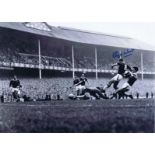 Autographed ROGER HUNT 16 x 12 photo - B/W, depicting the Liverpool forward scoring a dramatic