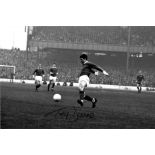 Football Tony Dunne signed 14x10 black and while pictured in action for Manchester United. Good
