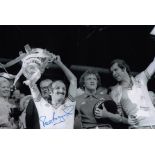 Autographed PETER RODRIGUES 12 x 8 photo - B/W, depicting the Southampton captain holding aloft