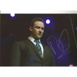 Russell Watson signed 12x8 colour photo of the singer performing on stage. Good Condition. All