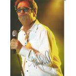 Huey Lewis signed 10x8 colour photo. Image taken during one of his many performances. Good