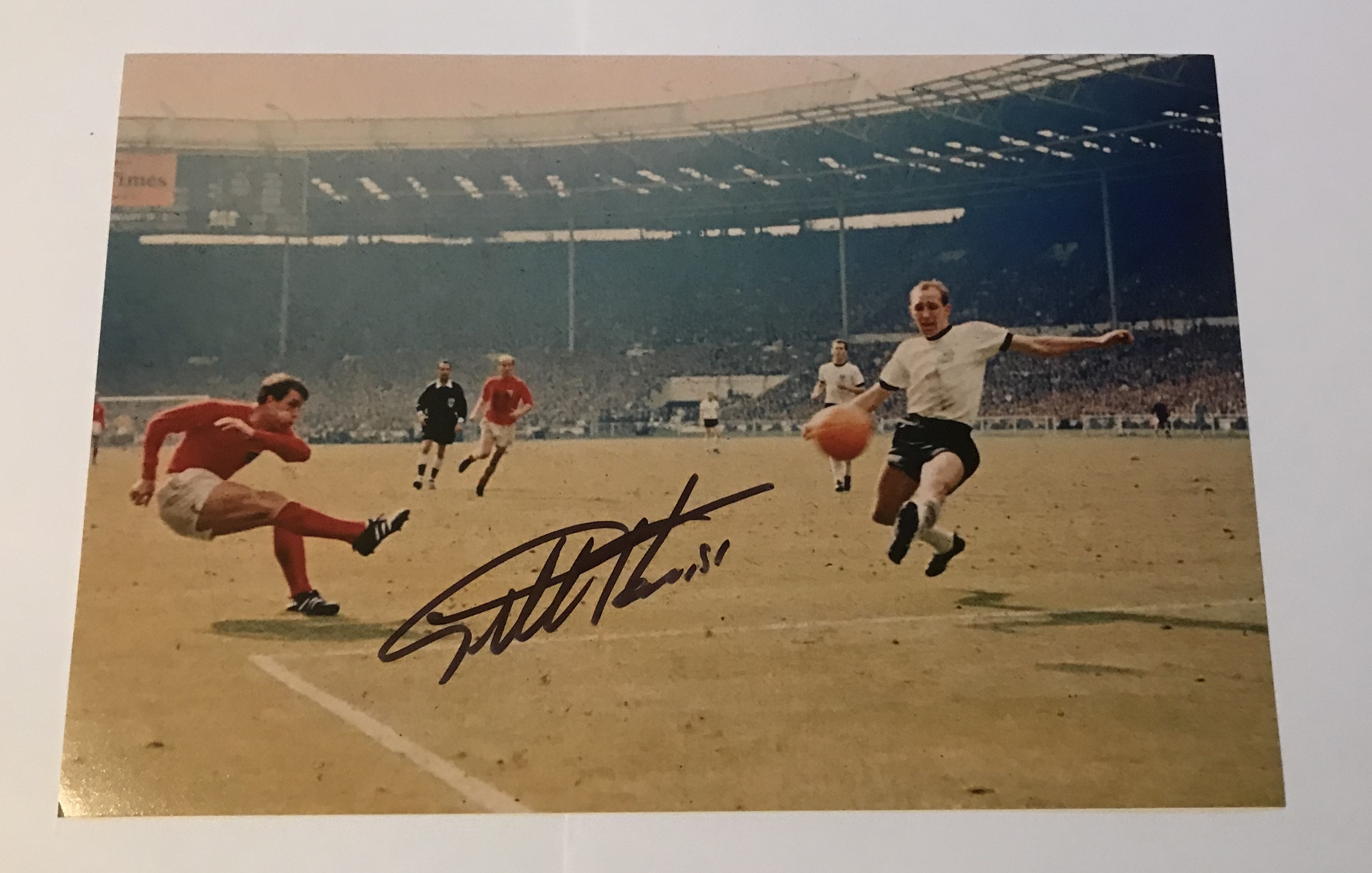 Geoff Hurst signed 12 x 8 inch colour photo scoring in 1966 football World Cup Final. Good