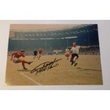 Geoff Hurst signed 12 x 8 inch colour photo scoring in 1966 football World Cup Final. Good