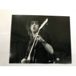 Mick Jones The Clash signed 10 x 8 inch b/w photo on stage playing guitar. Good condition. All