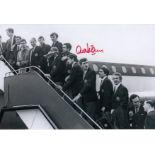 Autographed Alex Stepney 12 X 8 Photo - B/W, Depicting Man United Players Boarding A Plane For Their