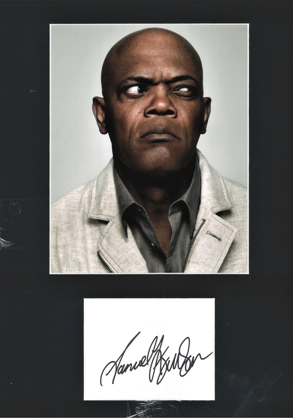 Samuel L Jackson signature piece mounted below colour photo. Approx overall size 16x12. Good