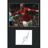 Wayne Rooney signature piece mounted below colour photo. Approx overall size 16x12. Good