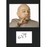 Verne Troyer signature piece mounted below colour photo. Approx overall size 16x12. Good