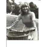 Felicity Kendal signed 10x8 black and white image. Feasting her smiling riding a bicycle. Good