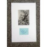 Betty Grable signed album page mounted below black and white photo. (December 18, 1916 - July 2,