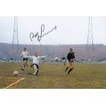 Autographed Bobby Lennox 12 X 8 Photo Col, Depicting The Scottish Midfielder Shooting At Goal