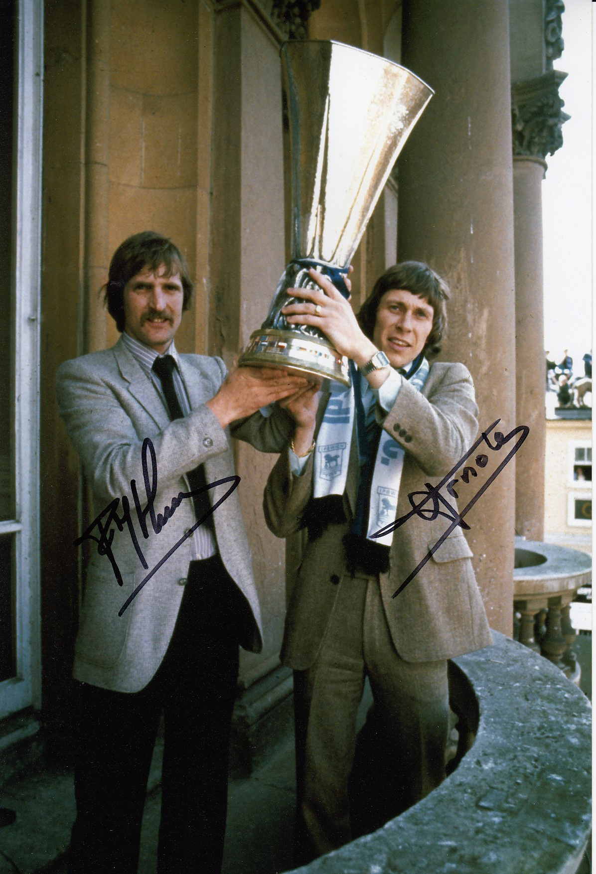 Autographed Ipswich 12 X 8 Photo Col, Depicting Frans Thijssen And Arnold Muhren Holding Aloft The