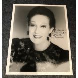 Dorothy Lamour signed 10 x 8 inch b/w photo dedicated, info card fixed to reverse. Condition 9/10.