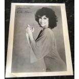Rita Moreno signed 10 x 8 inch b/w photo; career info card fixed to reverse. Condition 7/10. All