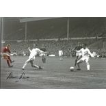 Denis Law signed 12x8 colourised photo pictured in action for Manchester United. Denis Law CBE (born