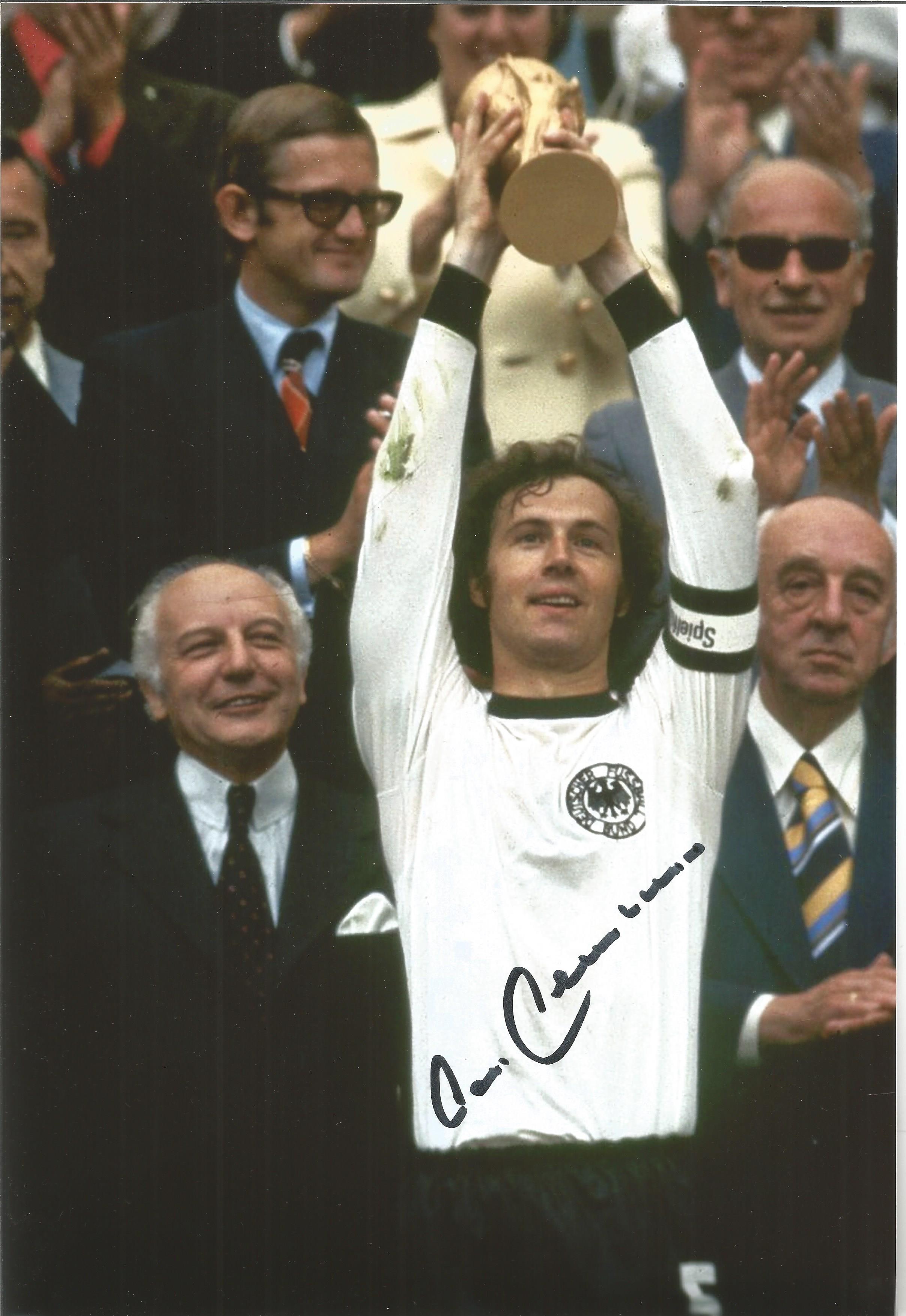 Franz Beckenbauer signed 12x8 colour photo pictured lifting the World Cup in 1974 for West