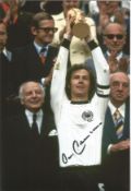 Franz Beckenbauer signed 12x8 colour photo pictured lifting the World Cup in 1974 for West