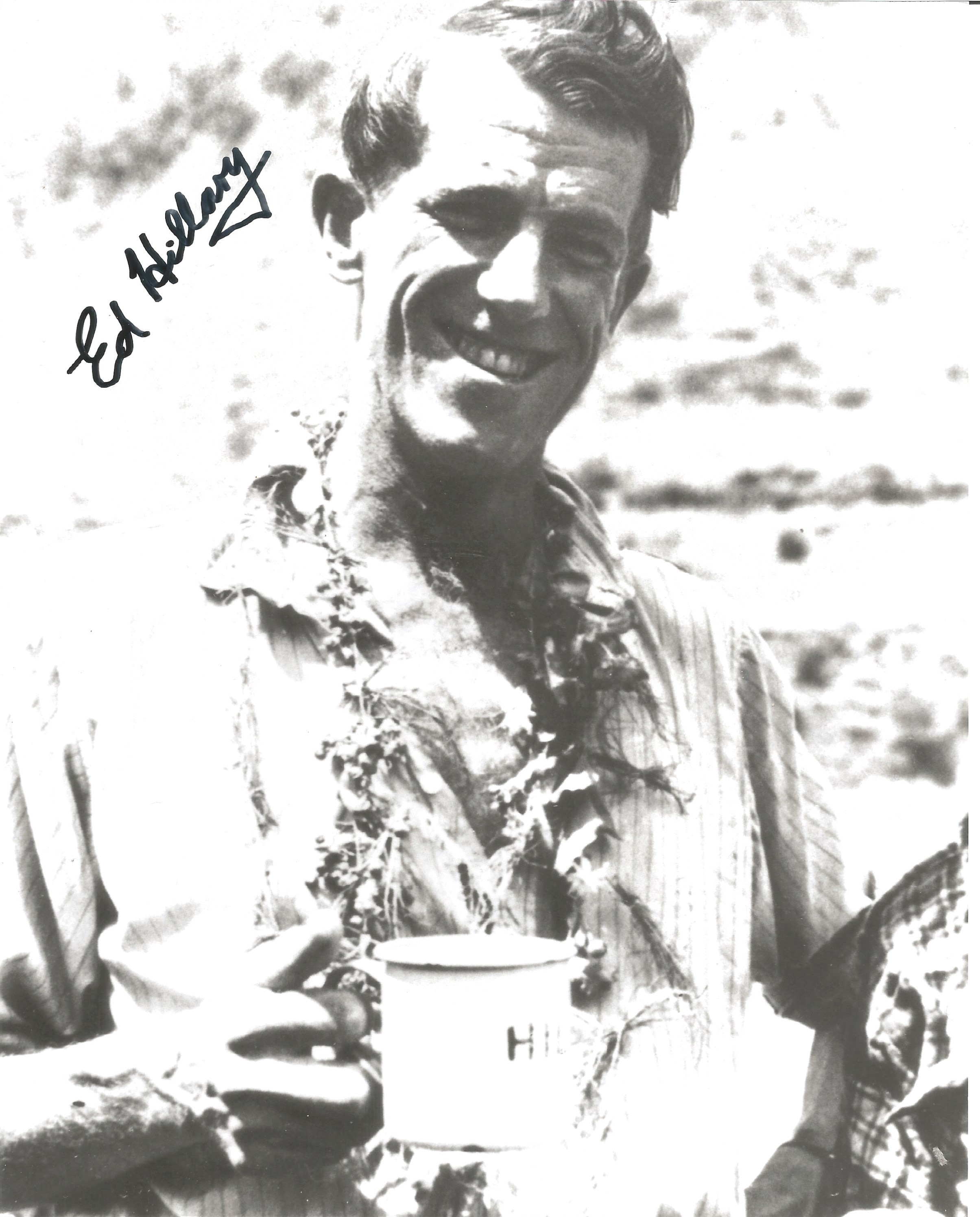 Sir Ed Hillary signed 12 x 8 inch b/w photo smiling shot with mug of tea in hand. Good condition.