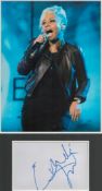 Emeli Sande signature piece in autograph presentation. Mounted with photograph to approx. 16 x 12