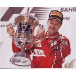 Sebastian Vettel 10x8 signed photo holding trophy. Good condition. All autographs come with a