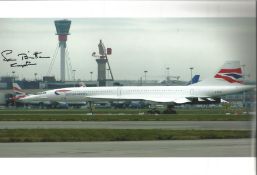 Concorde pilot Capt Norman Britten signed 12 x 8 inch colour photo of Concorde on tarmac parked..