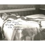 James Bond Shirley Eaton signed 10 x 8 inch b/w photo from Goldfinger, lying on bed covered in Gold.