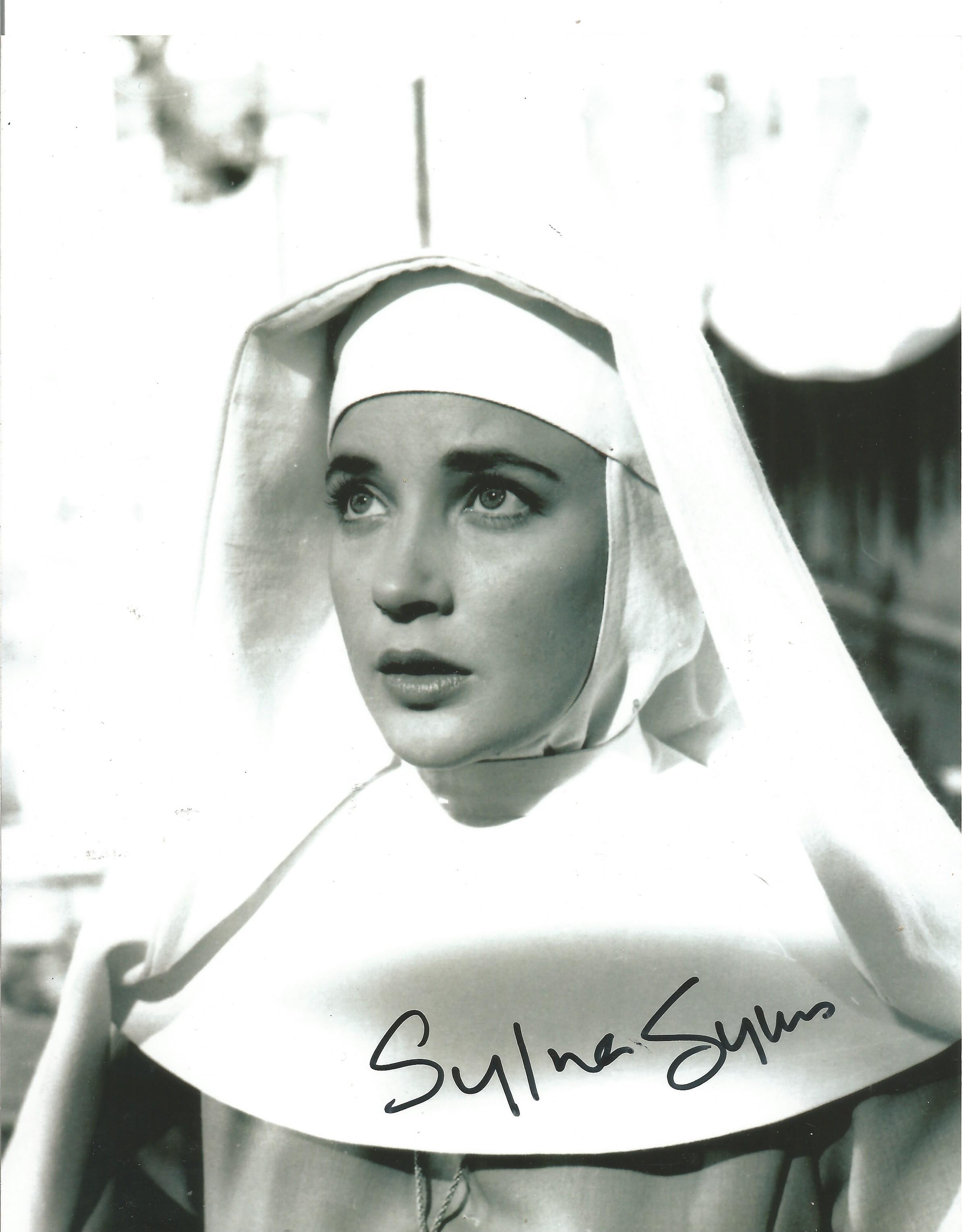 Sylvia Syms Signed 10x8 black and white photo. Photo shows Syms wearing a Nun's Robe. Sylvia May