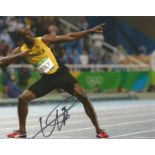 Usain Bolt signed 12 x 8 inch Athletics photo in classic pointing pose.