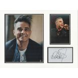 Robbie Williams music signature piece autograph presentation. Mounted with two unsigned photos to