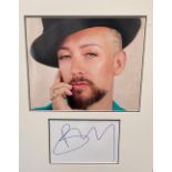 Boy George signature piece autograph presentation. Mounted with unsigned photo to approx. 16 x 12