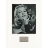 Rita Hayworth matted signature piece featuring a black and white photograph and a signed card.