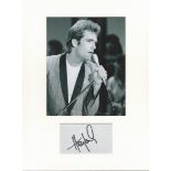 Huey Lewis music, signature piece autograph presentation. Mounted with unsigned photo to approx.
