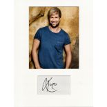 Kian Egan music, signature piece autograph presentation. Mounted with unsigned photo to approx. 16 x