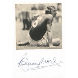 Bobby Moore signature on card below black and white newspaper photo. Overall size approx 6x4. 12