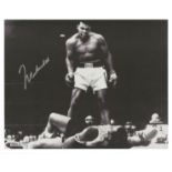 Muhammad Ali signed 10 x 8 inch b/w boxing photo standing over Sonny Liston