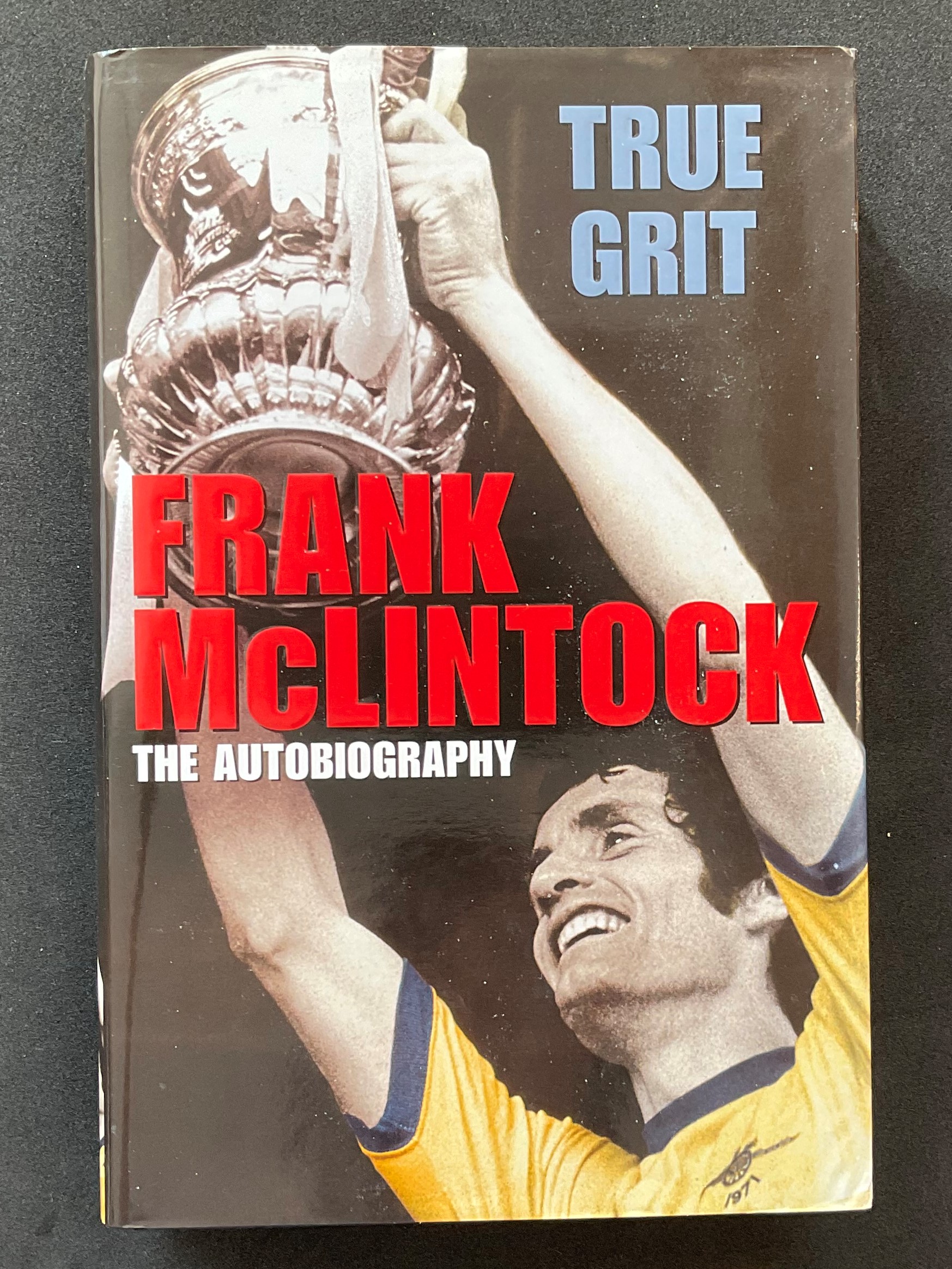 Footballer Frank McLintocks autobiography True Grit signed hardback copy dedicated to Peter and