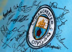 Football. Manchester City Hand signed 16x12 colour photo. Photo shows the Man City Crest up close.