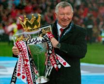 Football. Sir Alex Ferguson Hand signed 10x8 Colour photo. Photo shows Ferguson holding aloft the