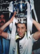 Football. Ossie Ardiles Signed 16x12 colour photo. Photo shows Ardiles with a trophy on his head.