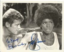 Roger Moore and Gloria Hendry Rosie Carver Handsigned Black and White Photo. Photo shows Bond facing